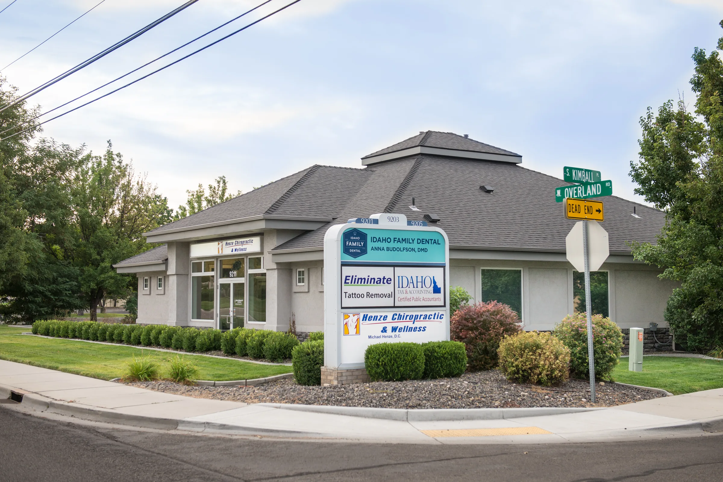 Exterior of Henze Chiropractic & Wellness medical office building with signage at corner intersection.
